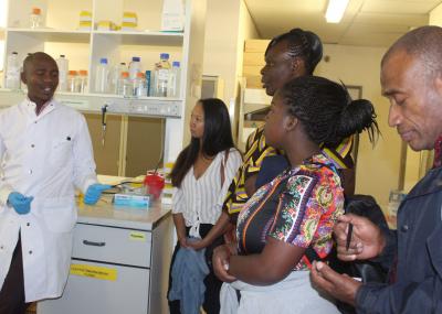 Lab Scientist, explaining laboratory process to visitors at the BHP Laboratory